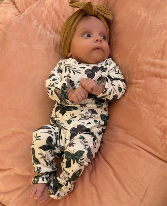 Baby in dark butterfly jumpsuit