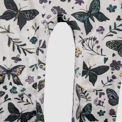 Close-up of snaps with butterfly and floral pattern on a white background