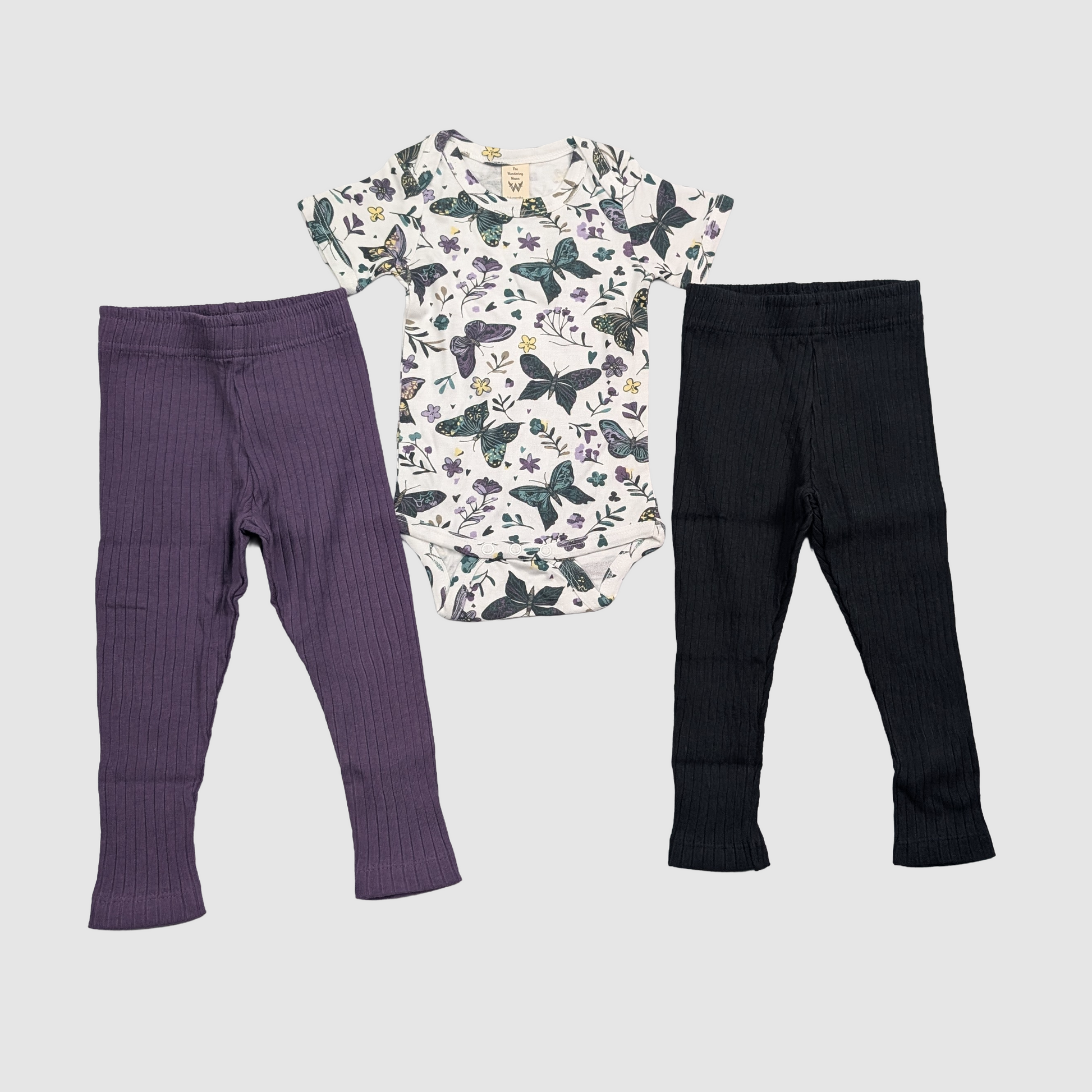 Two pairs of kids pants and a dark butterfly onesie